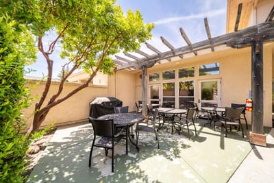 Outdoor seating area with tables and shaded pergola