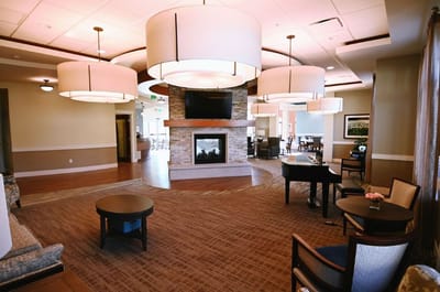 Bright common area with seating and a fireplace
