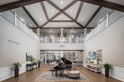 Interior view of a spacious common area with seating and piano