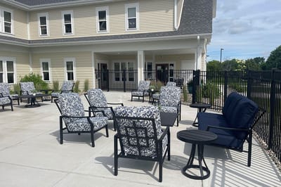 Outdoor patio area with seating at a senior living facility