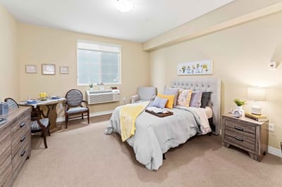 Cozy resident room with a bed and seating area