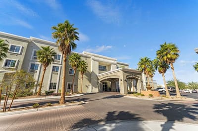 Building exterior with palm trees and entrance