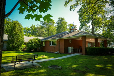 Exterior view of a building with landscaping and seating
