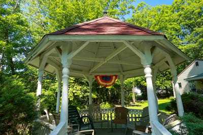 A gazebo surrounded by trees in a peaceful garden