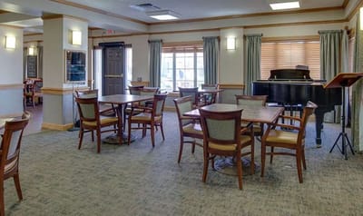 Common area with piano and dining tables