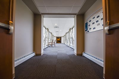 Interior hallway with large windows and carpet