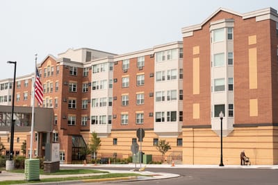 Exterior view of a senior living facility with landscaping