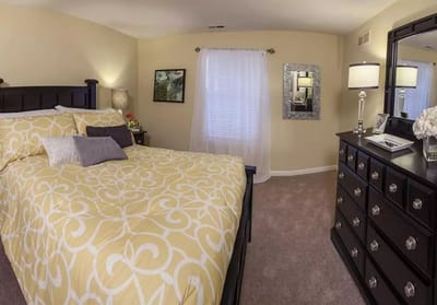 Cozy bedroom with a patterned bedspread and furnishings