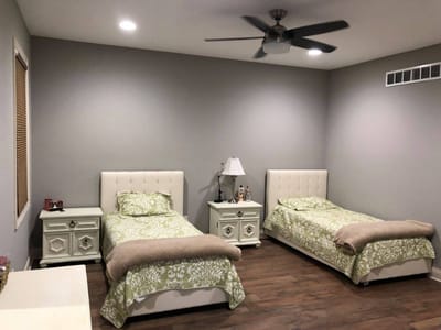 Two twin beds in a softly lit room