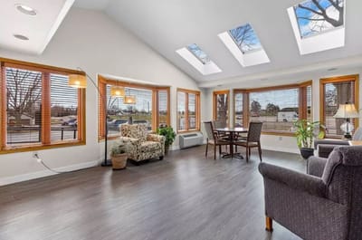 Bright common area with large windows and seating