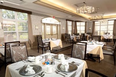 Elegant dining room with set tables for residents