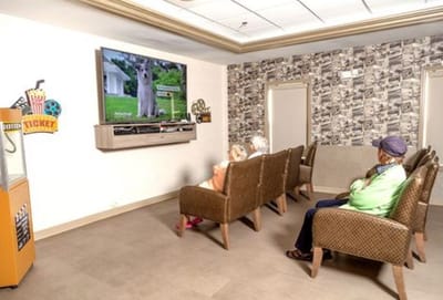 Residents enjoying a movie in the common area