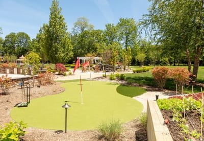 Beautiful outdoor garden with putting green and seating areas