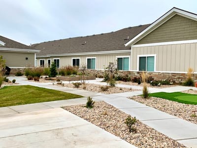 Pathway through landscaped outdoor area with building