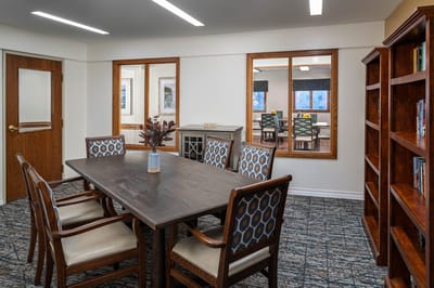 Common area with dining setup and bookshelves