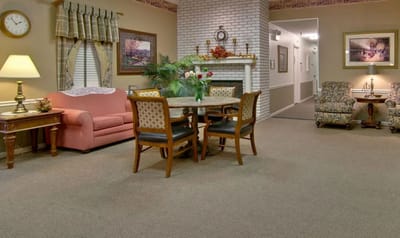 Bright common area with sofas and a dining table