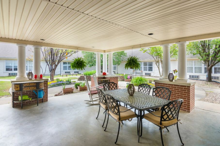 Outdoor patio area with seating and greenery