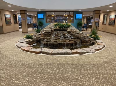 Interior view of a lobby with a water feature