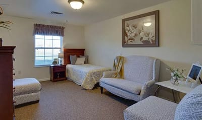 Cozy interior of a resident room with a bed and seating