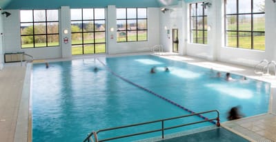 Indoor pool area with residents swimming