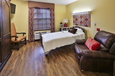 Cozy resident room with a bed and seating area