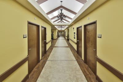 Bright hallway with yellow walls and doors