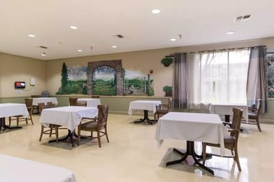 Dining area with tables and mural in the background