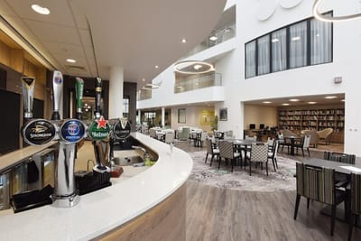 Bright common area with seating and a bar