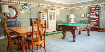 Common area with a pool table and dining table