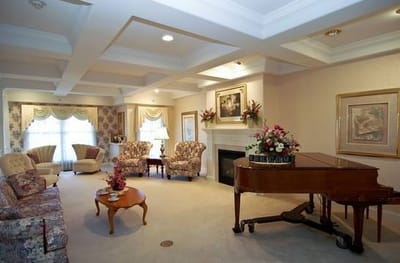 Bright common area with comfortable seating and a piano