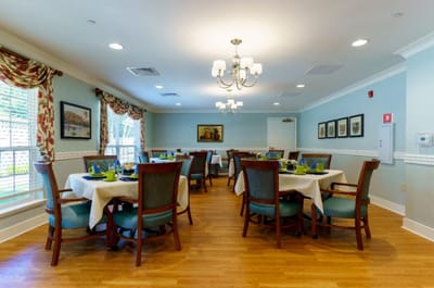 Bright dining room with tables set for a meal