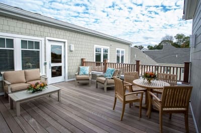 Outdoor patio area with seating and flowers