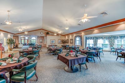 Dining room set up for a meal with decorative tables
