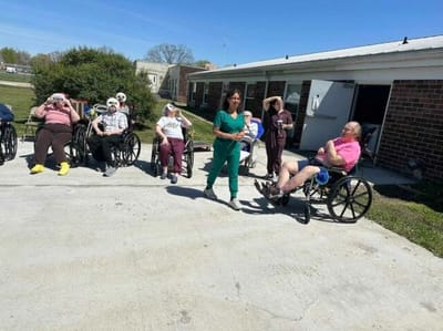 Residents enjoying time outside in wheelchairs