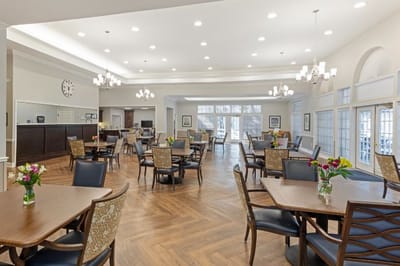 Bright dining room with tables and flowers