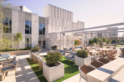 Outdoor seating area with modern furniture and landscaping