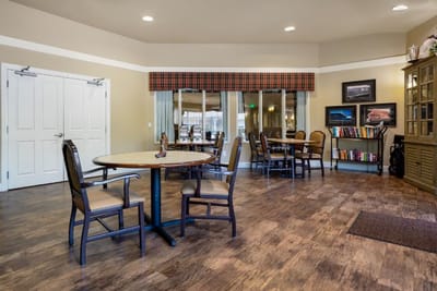 Common area with tables and chairs in a cozy setting