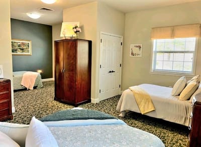 Private resident room with two beds and warm decor