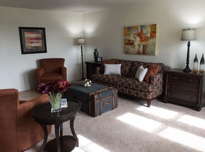 Cozy sitting area with soft furniture and artwork