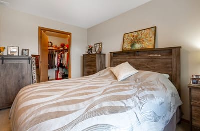 A well-furnished bedroom with a bed and closet