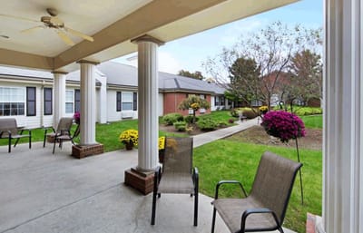 Outdoor patio area with seating and flower beds