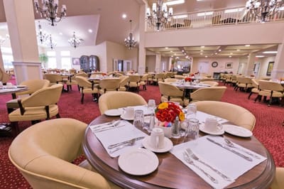 Bright dining room with tables set for a meal