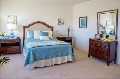 Cozy bedroom setup with a blue theme and natural light