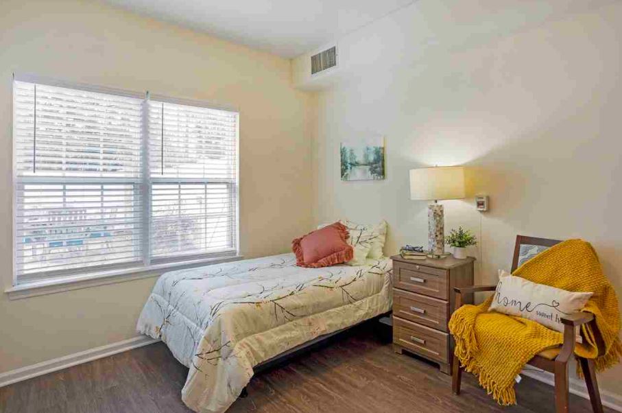 Cozy resident room with a bed and lamp