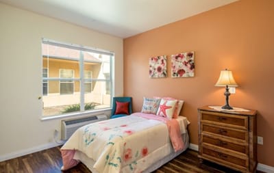 Cozy resident room with floral decor and bright lighting