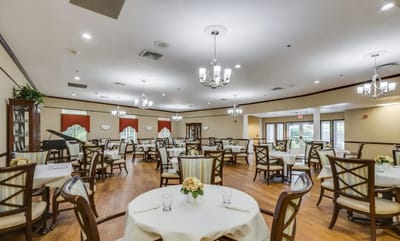 Dining room set up for residents with tables and chairs