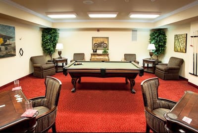 Interior view of a common area with a pool table and seating