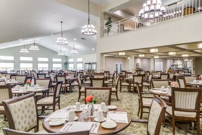 Bright dining room with tables set for meals