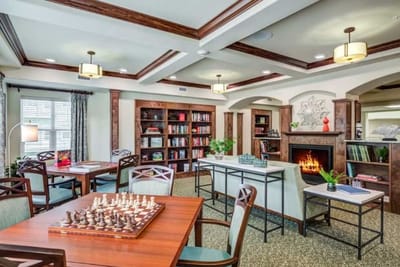Bright common area with chess tables and bookshelves