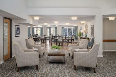 Bright interior common area with seating and dining space